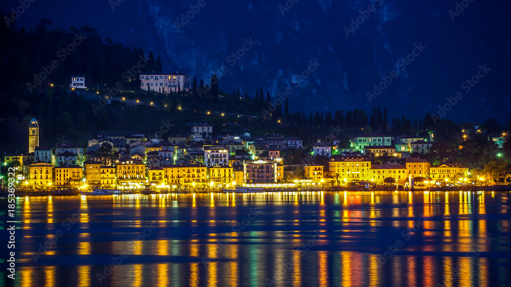 Bellagio lit up gold and blue at twilight on Lake Como, Italy