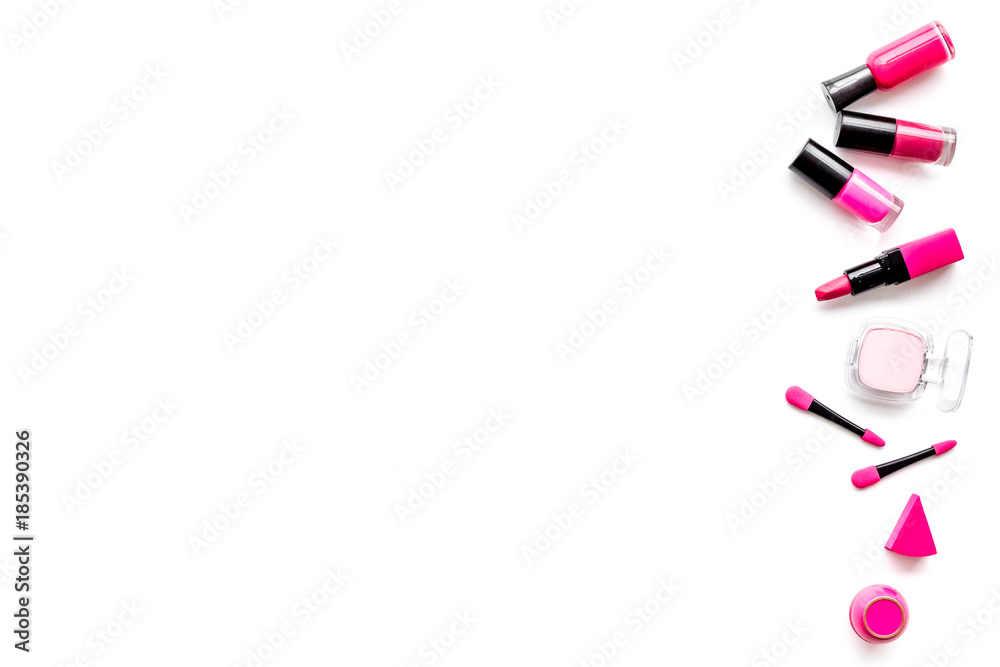 Makeup set. Eyeshadows, lipstick, nailpolish, applicators on white background top view copyspace Makeup set. Eyeshadows, lipstick, nailpolish, applicators on white background top view copyspace
