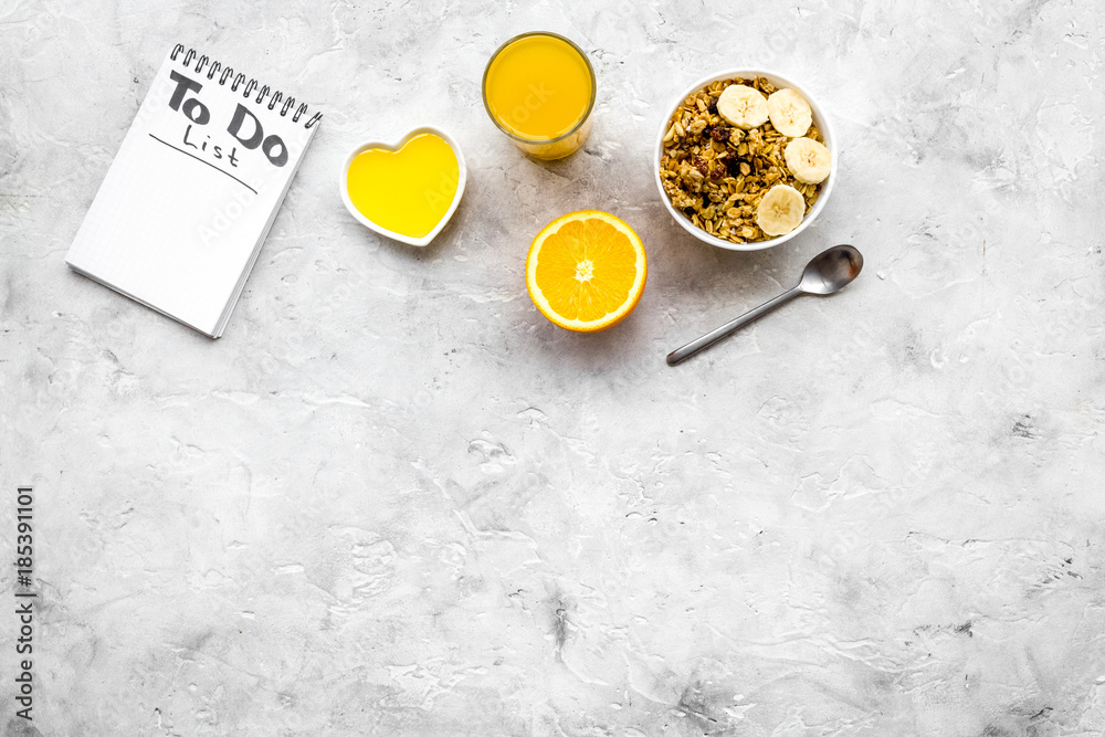 Start the day the right way. Healthy breakfast oatmeal with fruits and planning the day. Grey background top view copyspace Start the day the right way. Healthy breakfast oatmeal with fruits and planning the day. Grey background top view copyspace