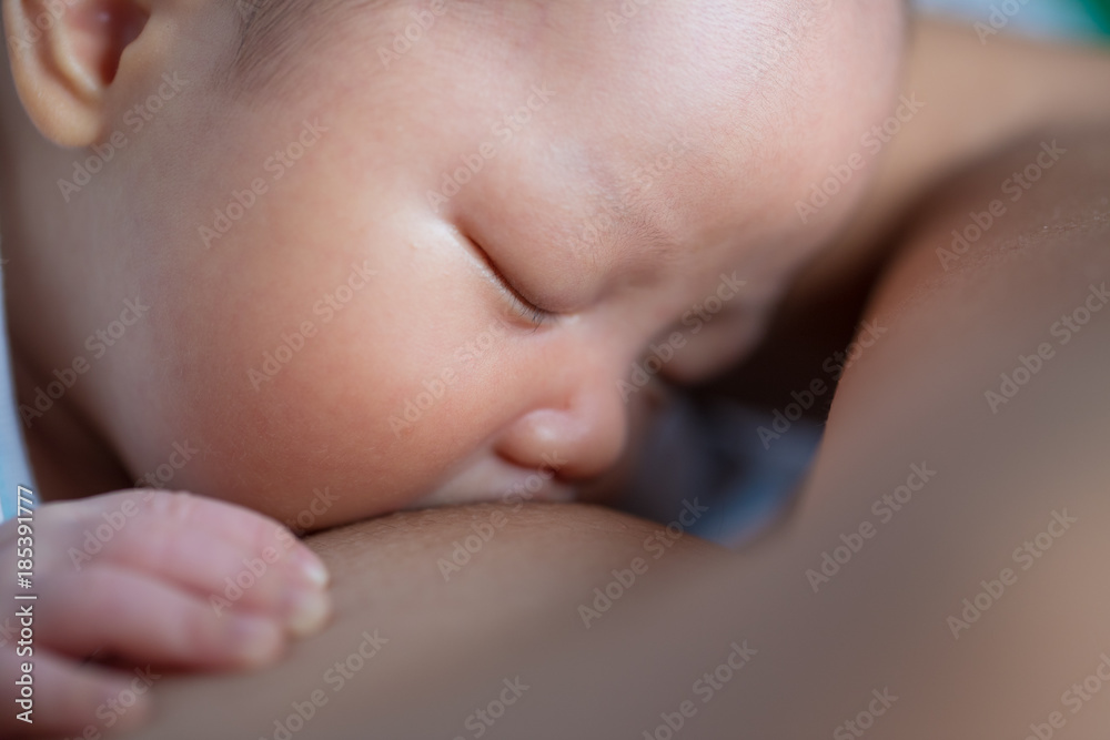 Asian baby boy breastfeeding top view