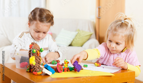 Preschoolers molding figurines from plasticine .