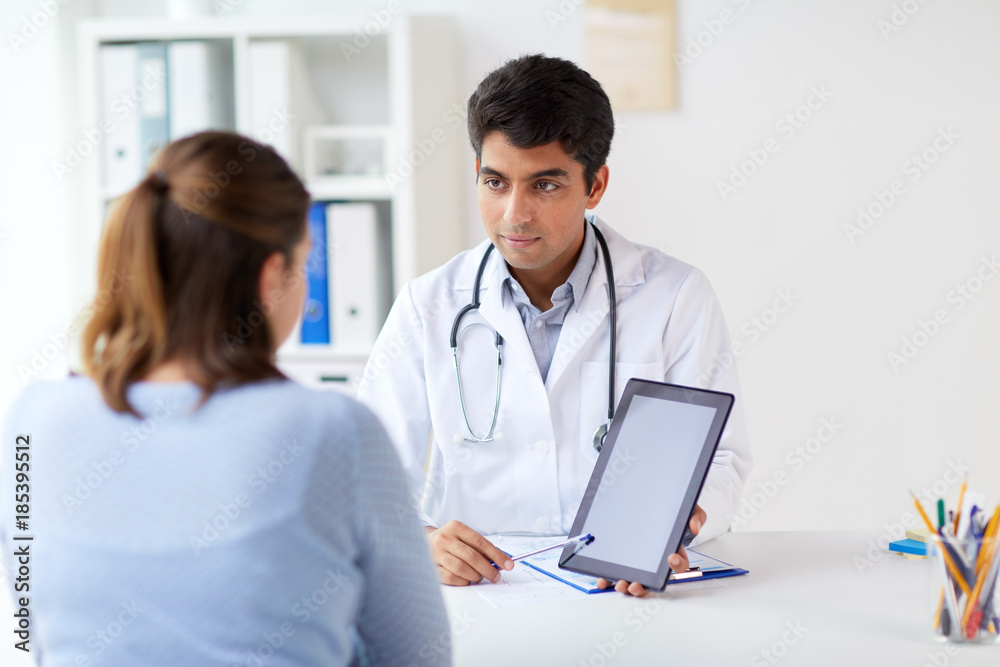 doctor showing tablet pc to patient at clinic doctor showing tablet pc to patient at clinic