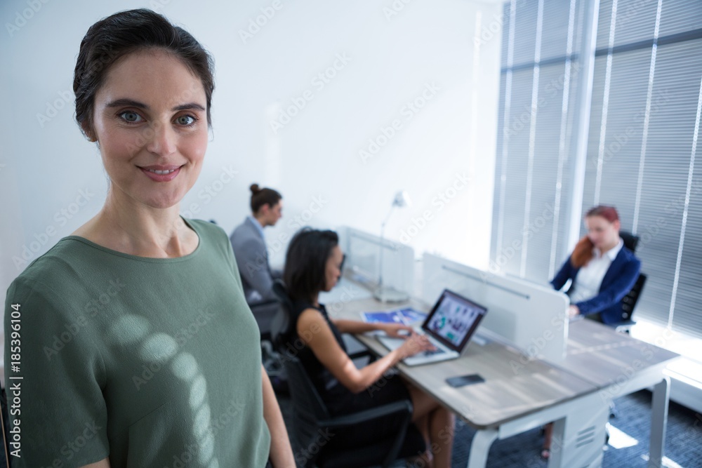 Beautiful female executive looking at camera