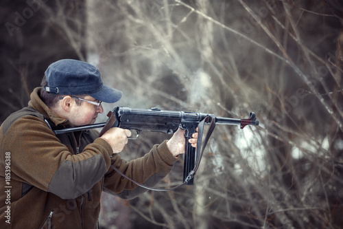 young man shoots from a German submachine gun