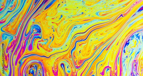 Macro shot of a soap bubble creates a colorful and psychedelic background. photo