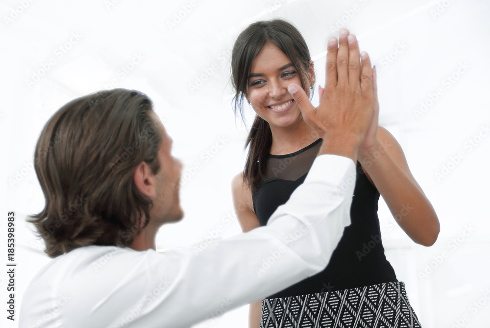 handsome man and beautiful woman giving hi five handsome man and beautiful woman giving hi five