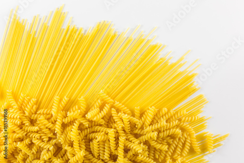 Pasta and spaghetti with wooden spoon with heart on the white background