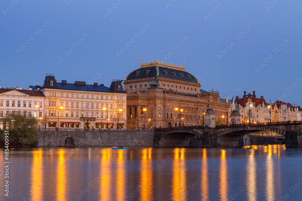 Evening view of illuminated embankment and the National theatre. Prague, Czech Republic