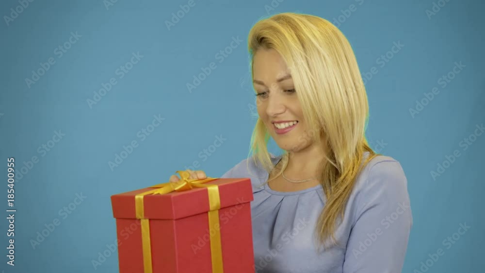 Happy young women take present. Happy blonde girl genred gift box with gold bow ribbon. Smile face of caucasian women. Happy young women take present. Happy blonde girl genred gift box with gold bow ribbon. Smile face of caucasian women.