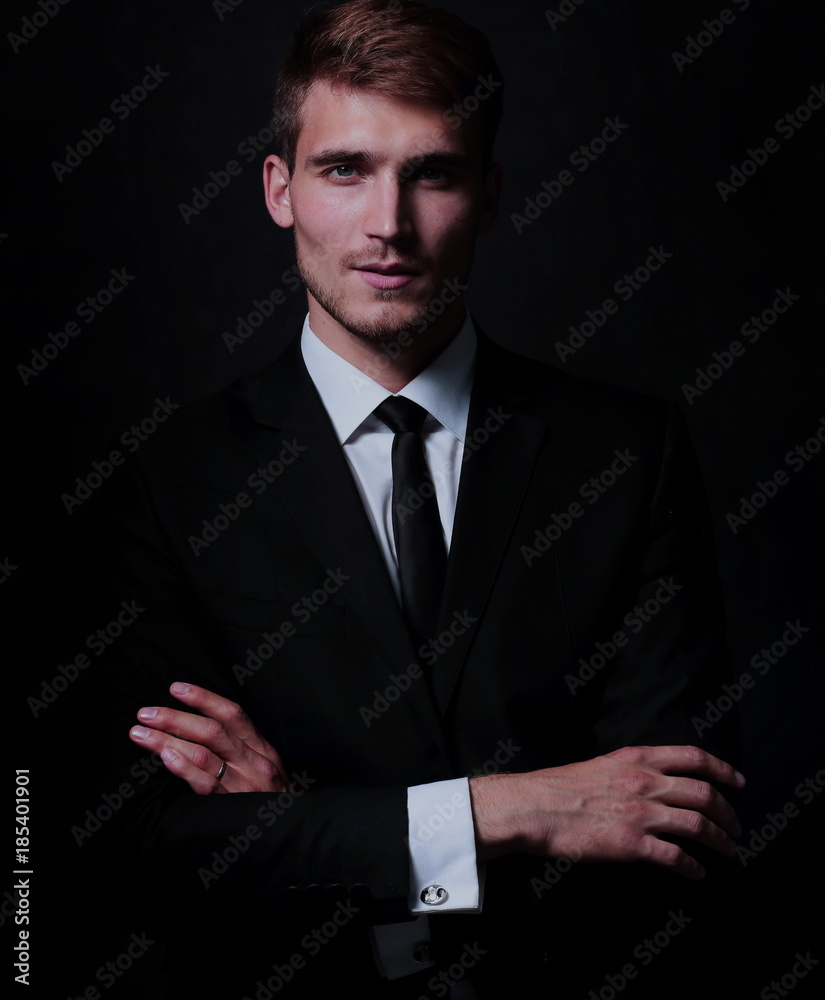 Full-length portrait of business man with arms crossed on black Full-length portrait of business man with arms crossed on black
