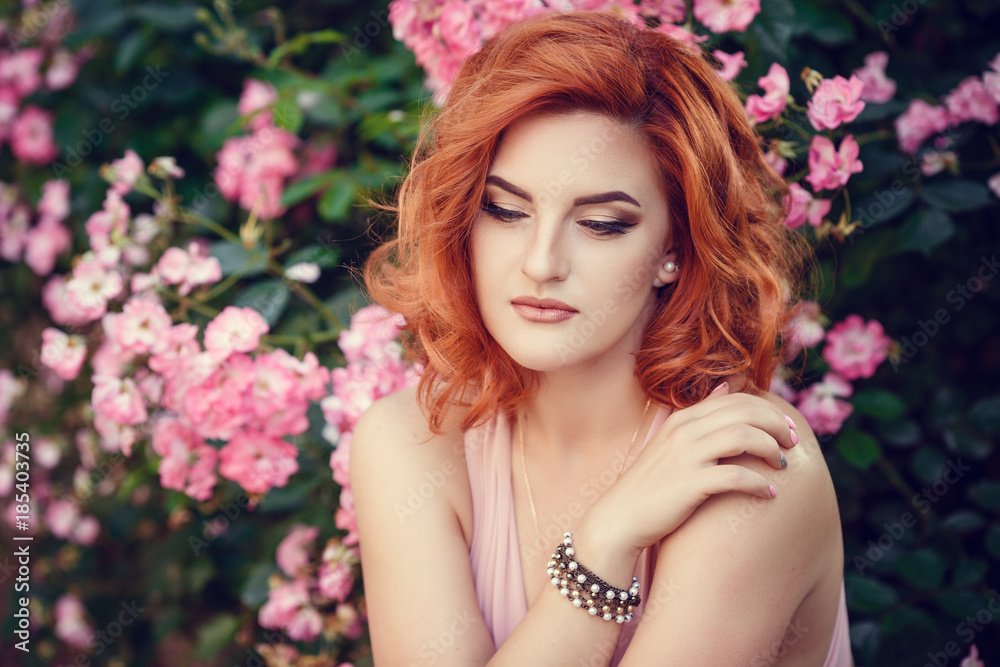 Fototapeta premium Lovely young woman in a pink dress, waiting for a date.