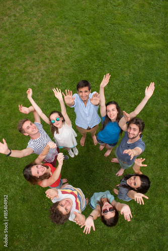Top view. Group of young people outdoors, they form a circle