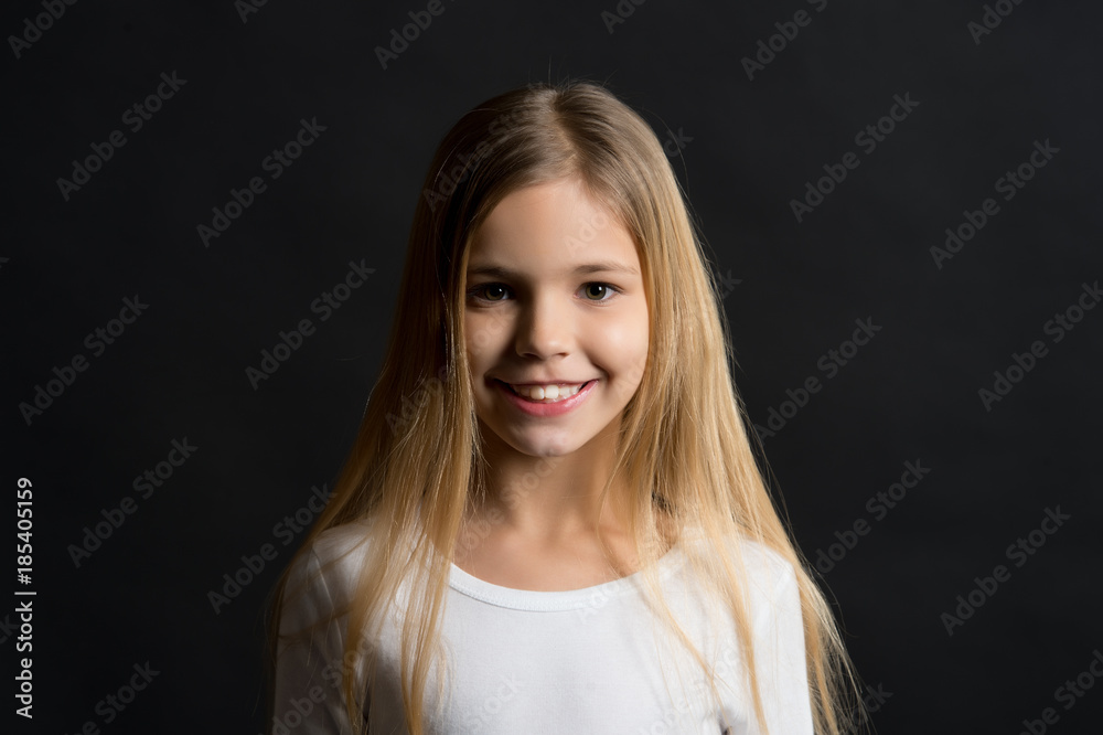 Kid model smiling with long healthy hair Kid model smiling with long healthy hair