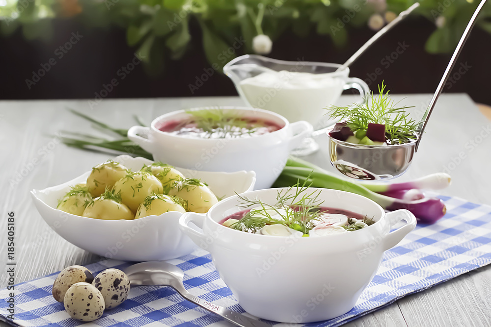 Cold vegetable soup with eggs  in white bowl on wooden table. Soft focus.