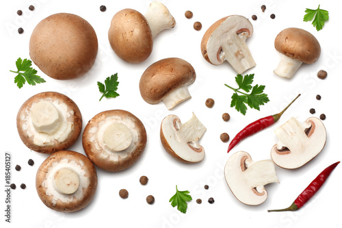 Fresh champignon mushrooms with parsley isolated on white background. top view