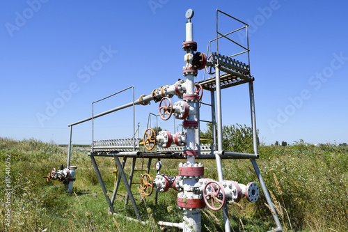 Well for oil and gas production. Oil well wellhead equipment. Oil production photo