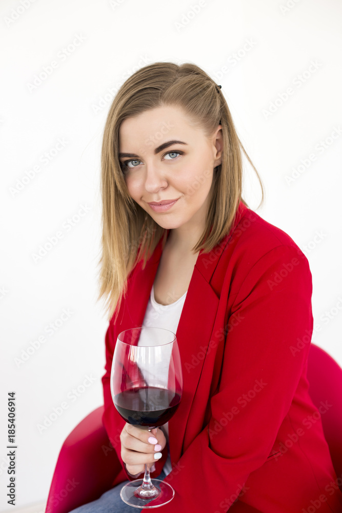 Charming blonde in the red jacket with wine Charming blonde in the red jacket with wine