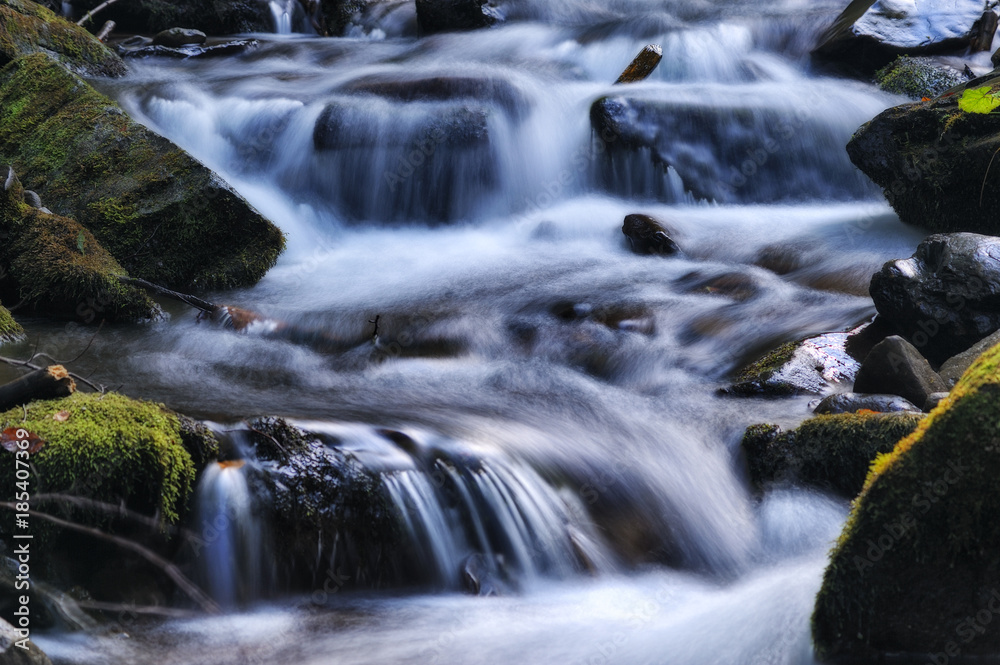 autumn waterfall. Picturesque creek in the Carpathian Mountains