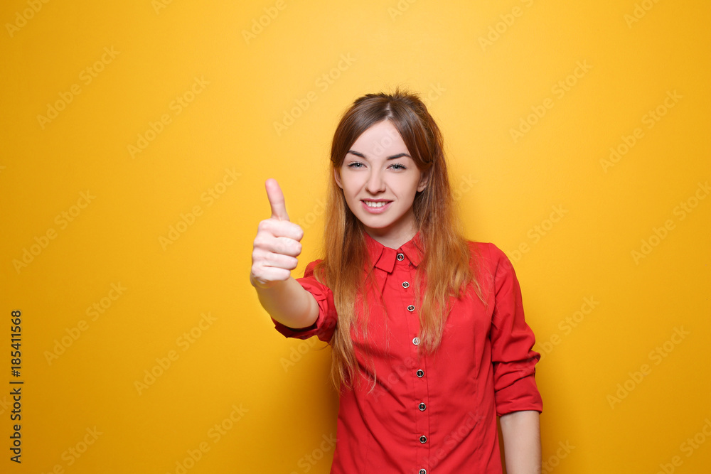 Young beautiful successful woman on color background