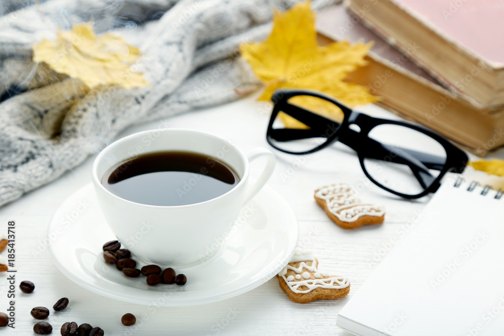 Cup of coffee with gingerbread cookies, glasses and dried leafs on wooden table Cup of coffee with gingerbread cookies, glasses and dried leafs on wooden table