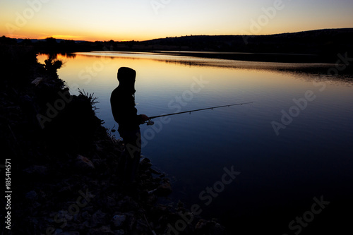 fishing at sunset near the sea.