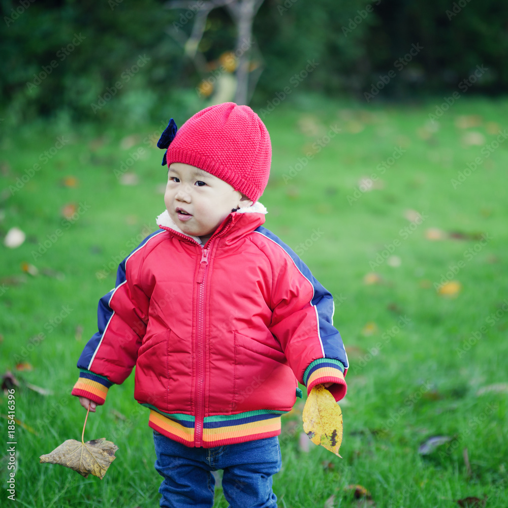 Baby girl playing at Autumn outdoor park Baby girl playing at Autumn outdoor park
