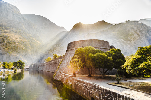 a picturesque mountain landscape, the fortress of the old town of Kotor at dawn, Montenegro photo