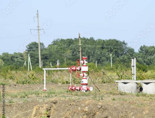 Well for oil and gas production. Oil well wellhead equipment. Oil production photo