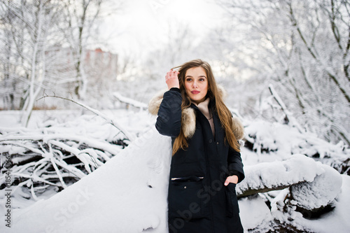 Beautiful brunette girl in winter warm clothing. Model on winter jacket.