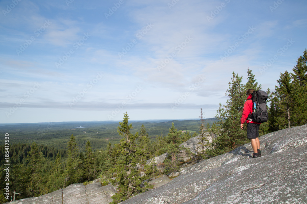 Fototapeta premium Hiker standing on the summit Akka-Koli and enjoys the natural landscape, summer 