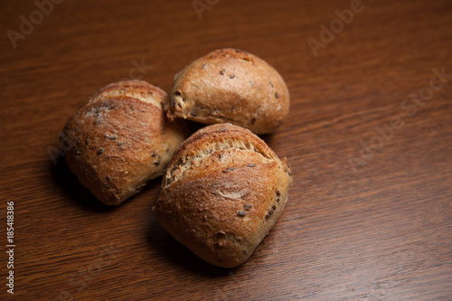 fresh baked bread with cereals on cutting board on wooden table