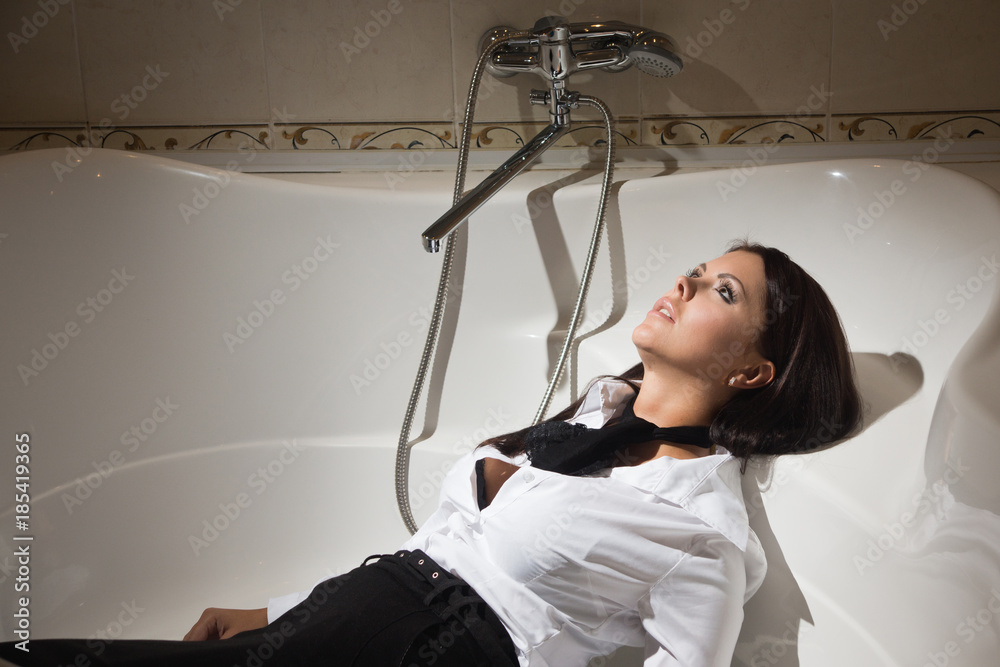 Strangled beautiful business woman in a bedroom. Photos | Adobe Stock