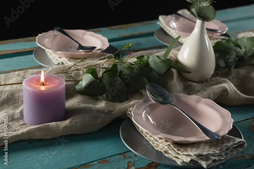 Fototapeta Naklejka Na Ścianę i Meble -  Elegance table setting with flower vase and lit candle