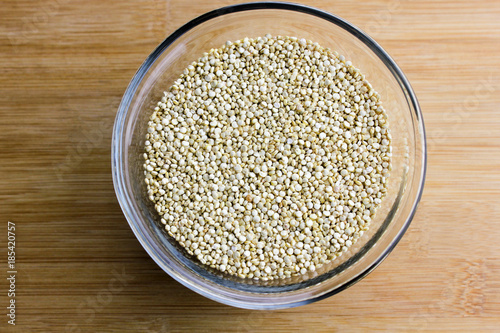 A glass bowl of dry quinoa