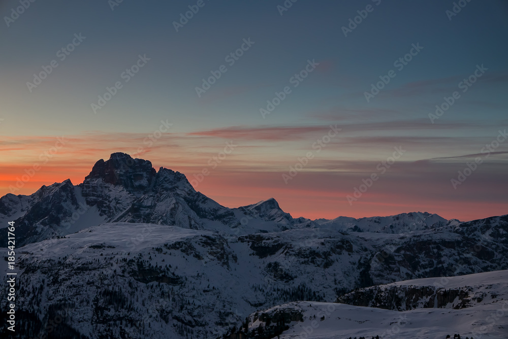 Obraz premium Aerial view of vivid beautiful sunset over winter alpine landscape