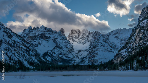 Evening in the winter mountain valley, alpie slope illuminated by reflected sunlight photo