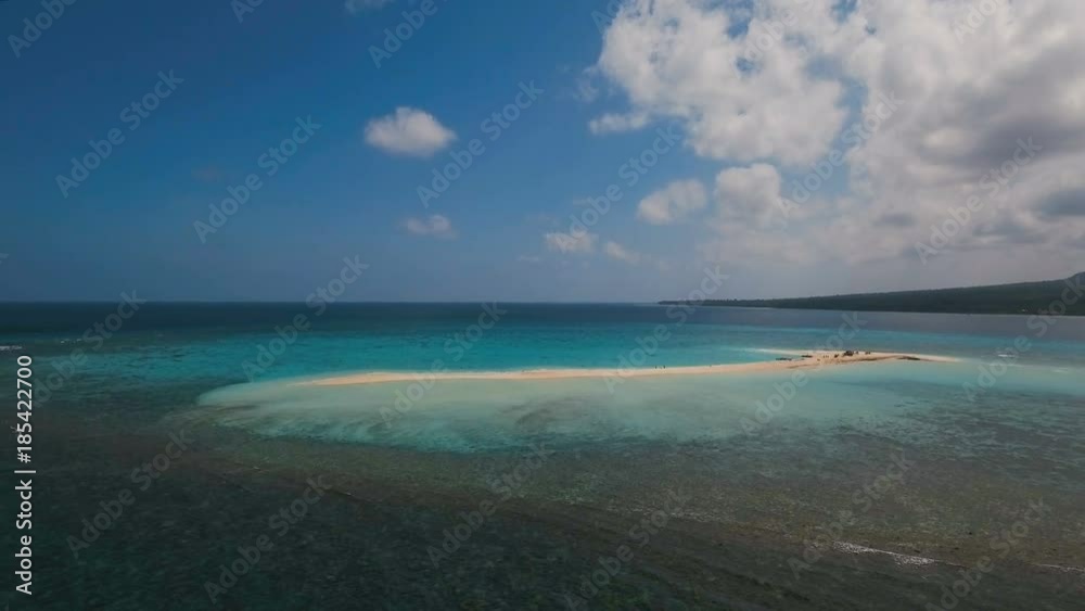 Aerial view of beautiful sand tropical island with white sand beach. White sand island. Beautiful sky, sea ,resort. Seascape: ocean and beautiful beach paradise. Philippines, Camiguin. 4K video