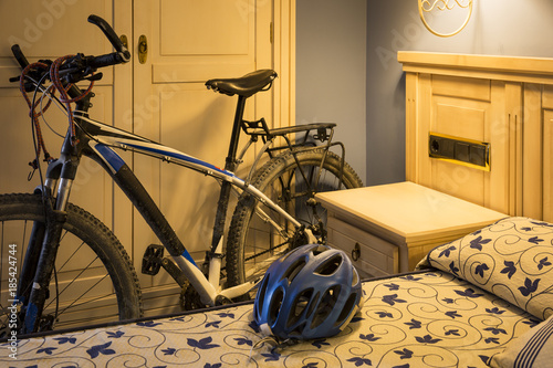 a mountain bicycle and a helmet in a hotel room - Bicycle touring