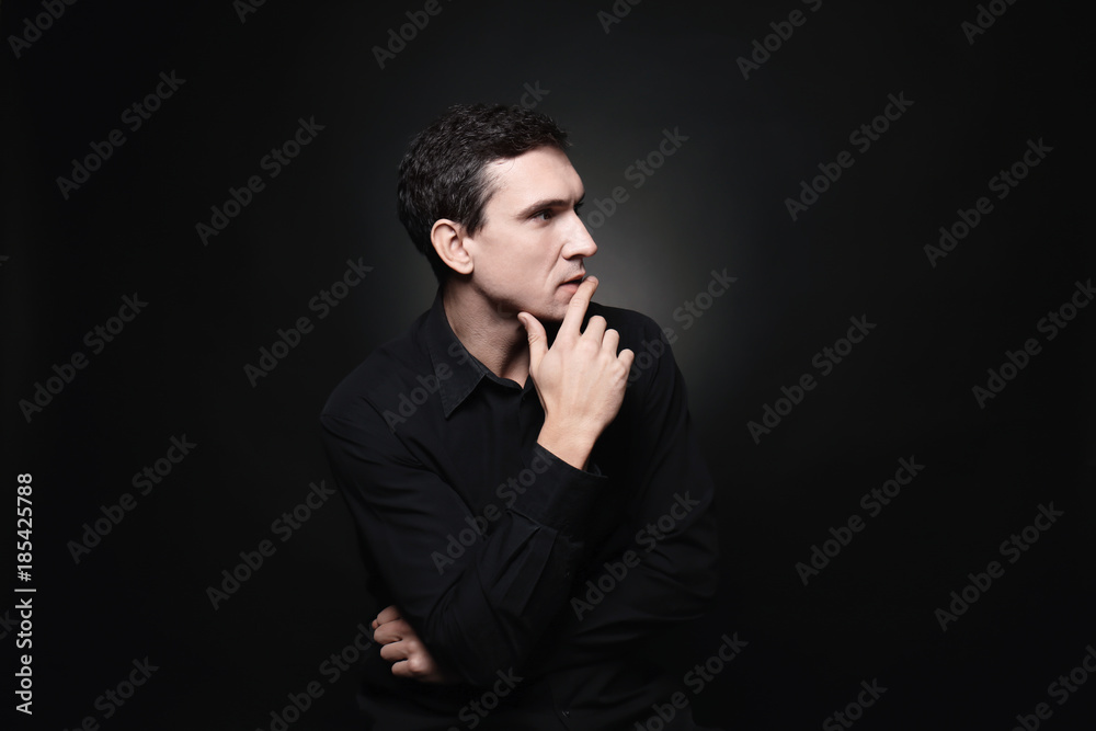 Fototapeta premium Attractive young man on black background