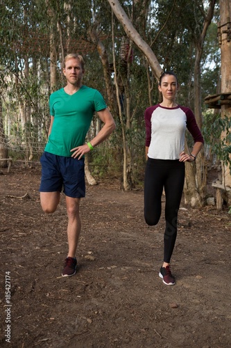 Woman exercising along with her trainer 