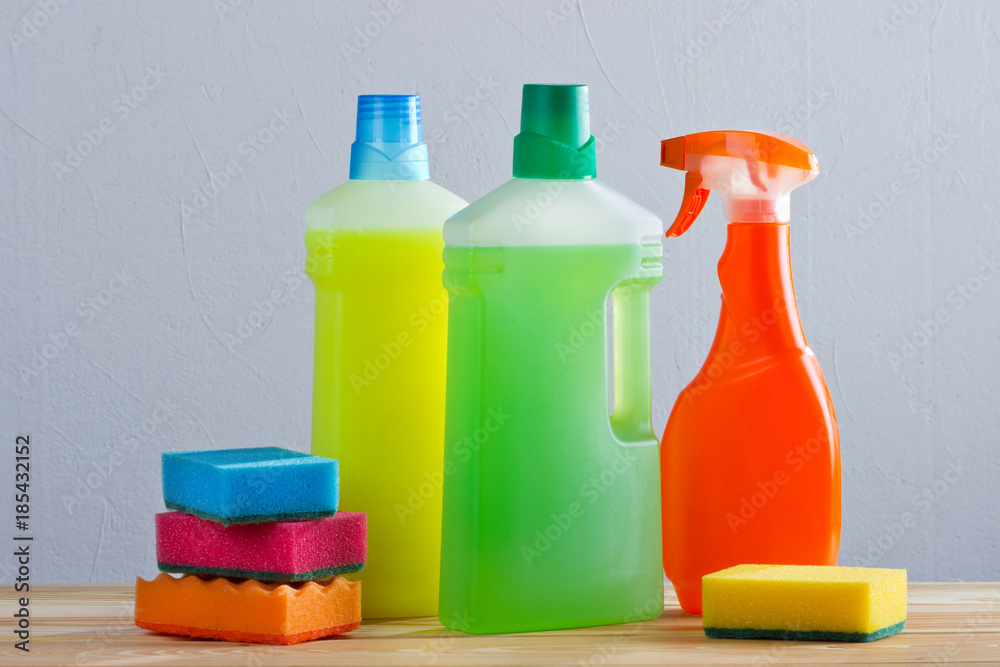 Colorful Cleaning concept with supplies on grey background Colorful Cleaning concept with supplies on grey background