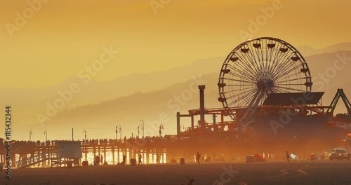 Golden sunlight illuminating Santa Monica Beach at sunset. 4K UHD. photo