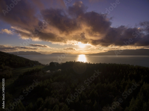 Sunset Over Orcas Island  Washington.  Aerial view of the sun setting over one of the San Juan Islands in the Puget Sound archipelago of Washington State.