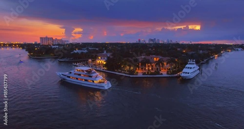 Miami cityscape at sunset, yachts, boats commuting on river 4K UHD aerial view