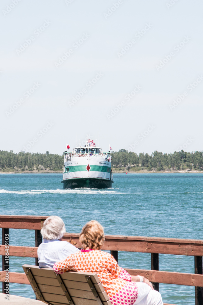 Fototapeta premium Lake Erie Ferry Couple Sitting on Bench, room for copy