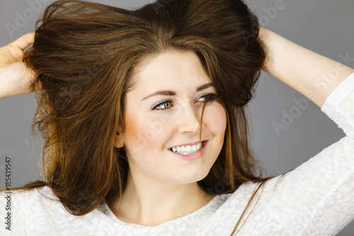Happy positive woman with long brown hair