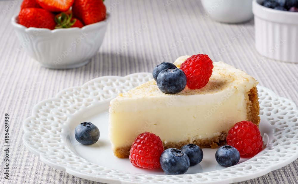 Delicious cheesecake with strawberry and blueberry on a table top view. Delicious cheesecake with strawberry and blueberry on a table top view.