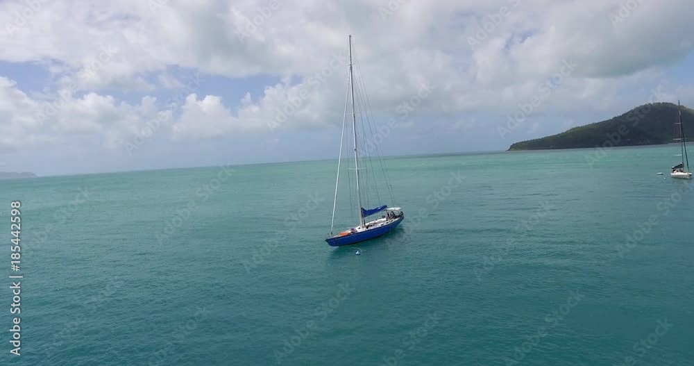 WHITSUNDAY ISLANDS – FEBRUARY 2016 : Aerial shot of sailboat at Whitehaven Beach on a beautiful day with amazing landscape and ocean in view WHITSUNDAY ISLANDS – FEBRUARY 2016 : Aerial shot of sailboat at Whitehaven Beach on a beautiful day with amazing landscape and ocean in view