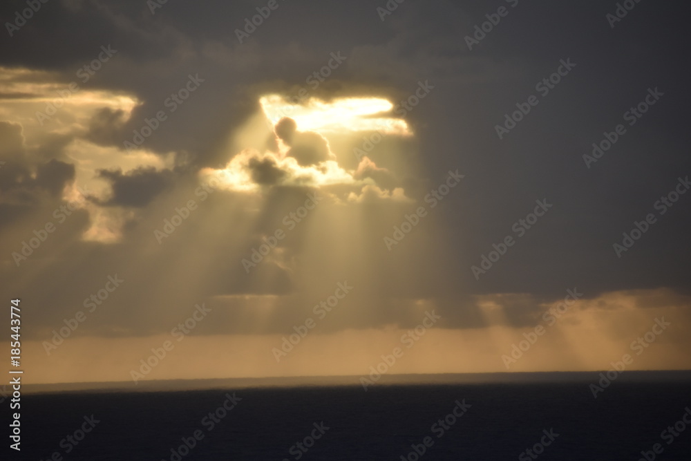 Fototapeta premium Sun Rays Peering from Dark Clouds