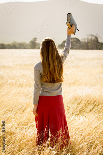 Girl Holding Bible in Air